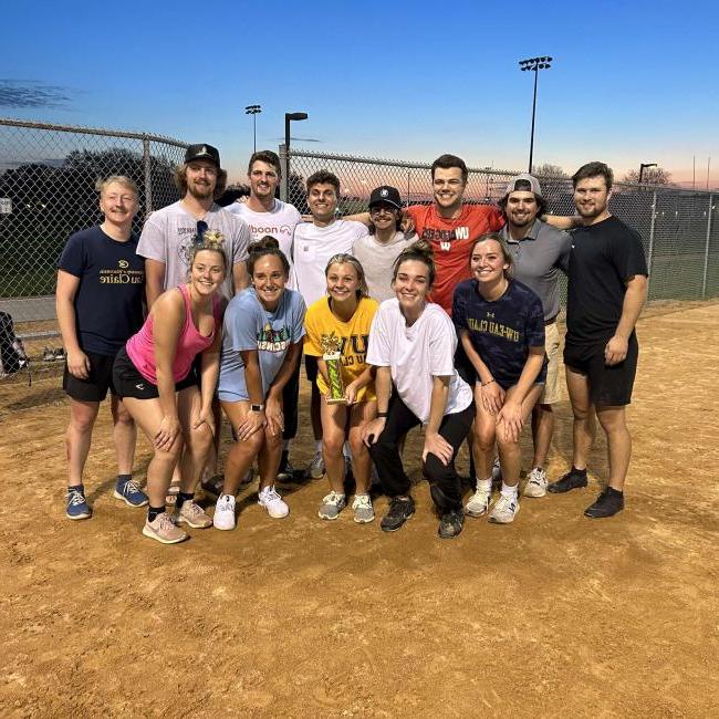 Intramural softball team poses with their trophy